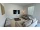 Living room with two sofas, a large TV, and floor cushions at 3203 Laurent Loop, Davenport, FL 33837