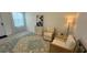 Cozy living room with two armchairs, side table, and patterned rug at 3203 Laurent Loop, Davenport, FL 33837