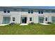 Three townhouses with private patios and small grassy backyards at 3207 Laurent Loop, Davenport, FL 33837