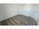 Bright bedroom with carpeted floors and double door closet at 3207 Laurent Loop, Davenport, FL 33837