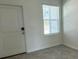 Bright entryway with neutral walls, gray flooring, and a white door at 3207 Laurent Loop, Davenport, FL 33837