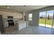 Kitchen with white cabinets, stainless steel appliances, and island, overlooking backyard at 3207 Laurent Loop, Davenport, FL 33837