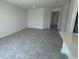 Open living area with gray tile floors and access to kitchen at 3207 Laurent Loop, Davenport, FL 33837