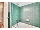Well-maintained retro bathroom with green tile and a tub at 3651 S Rosalind Ave, Orlando, FL 32806