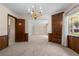 Dining room featuring built-in shelving, wood paneling, and a chandelier at 3651 S Rosalind Ave, Orlando, FL 32806