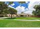 Traditional home featuring a manicured front lawn with a bright and sunny sky behind it at 3651 S Rosalind Ave, Orlando, FL 32806
