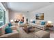 Brightly staged living room with contemporary furniture, accent pillows, and large windows at 3651 S Rosalind Ave, Orlando, FL 32806