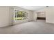 Spacious living room with large windows and neutral carpet at 3651 S Rosalind Ave, Orlando, FL 32806
