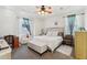 Main bedroom with a king-size bed, seating area, and ceiling fan at 5372 Sw 109Th Place Rd, Ocala, FL 34476