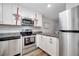 Modern kitchen featuring stainless steel appliances and white cabinets at 891 Jonathan Way, Altamonte Springs, FL 32701