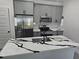 Modern kitchen featuring grey cabinets, stainless steel appliances, and island with quartz counters at 0 Robinson Dr, Haines City, FL 33844