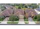 Aerial view of three homes with tile roofs in a community at 10713 Berry Creek Rd, Orlando, FL 32836