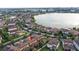Home's location is shown within a community featuring a lake and many other houses at 10713 Berry Creek Rd, Orlando, FL 32836