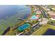 Aerial view of community pool, tennis court, and lake at 10713 Berry Creek Rd, Orlando, FL 32836