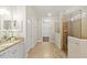 Bright bathroom with granite countertops, and a glass-enclosed shower with a built-in seat at 10713 Berry Creek Rd, Orlando, FL 32836