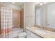 Clean bathroom with tub shower, granite vanity, and flamingo shower curtain at 10713 Berry Creek Rd, Orlando, FL 32836