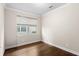 Bright bedroom with hardwood floors and large window at 10713 Berry Creek Rd, Orlando, FL 32836