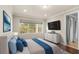 Main bedroom with hardwood floors, large window and a dresser at 10713 Berry Creek Rd, Orlando, FL 32836