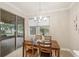 A cozy dining room with a modern chandelier, wood table, and sliding door to the outside patio at 10713 Berry Creek Rd, Orlando, FL 32836