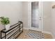 Welcoming entryway featuring a decorative glass door and stylish console table at 10713 Berry Creek Rd, Orlando, FL 32836