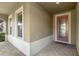 Front entrance with a decorative door and brick-paved walkway at 10713 Berry Creek Rd, Orlando, FL 32836
