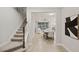 Bright foyer with stairs leading to an open-concept living and dining area at 10713 Berry Creek Rd, Orlando, FL 32836