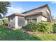 Home exterior showcasing a screened patio and landscaping at 10713 Berry Creek Rd, Orlando, FL 32836