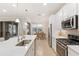 Stylish kitchen with a quartz countertop island, stainless steel appliances, and a view of the dining area at 10713 Berry Creek Rd, Orlando, FL 32836