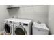 Laundry room with washer, dryer, and utility sink at 10713 Berry Creek Rd, Orlando, FL 32836