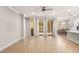 Open living room with tile floors, access to a patio, and kitchen views at 10713 Berry Creek Rd, Orlando, FL 32836