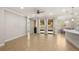 Open living room with tile floors, access to a patio, and kitchen views at 10713 Berry Creek Rd, Orlando, FL 32836