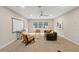 Cozy living room with comfortable seating, a ceiling fan, and large windows allowing for ample natural light at 10713 Berry Creek Rd, Orlando, FL 32836