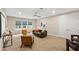 Cozy living room with comfortable seating and large windows allowing for ample natural light at 10713 Berry Creek Rd, Orlando, FL 32836