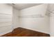 Large walk-in closet with wire shelving and wood flooring at 10713 Berry Creek Rd, Orlando, FL 32836