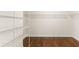 Large walk-in closet with wire shelving and wood flooring at 10713 Berry Creek Rd, Orlando, FL 32836