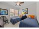 Cozy bedroom with twin beds and large window at 1348 Gilford Point Ln, Davenport, FL 33896