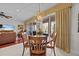 Bright dining room with wooden table and chairs, overlooking patio at 1348 Gilford Point Ln, Davenport, FL 33896