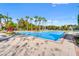 Resort-style community pool with lounge chairs and palm trees at 1348 Gilford Point Ln, Davenport, FL 33896