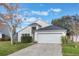 Single story house with a white garage door and well-maintained lawn at 3342 Kaleigh Ct, Saint Cloud, FL 34772