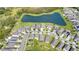 Aerial view of neighborhood with lake and houses at 3570 Southern Cross Loop, Kissimmee, FL 34744