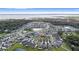 Aerial view of a house in a residential neighborhood near a lake at 3570 Southern Cross Loop, Kissimmee, FL 34744