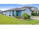 One story home with gray exterior, two car garage, and landscaped yard at 3570 Southern Cross Loop, Kissimmee, FL 34744