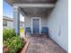 Covered porch with blue door and two rocking chairs at 3570 Southern Cross Loop, Kissimmee, FL 34744