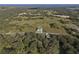 An aerial view of the property showing the house, land, nearby trees, and the neighborhood at 3705 Ridge Run Dr, Minneola, FL 34715