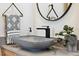 Stylish bathroom with a unique vessel sink, matte black faucet, and round mirror at 3705 Ridge Run Dr, Minneola, FL 34715