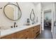 Elegant bathroom featuring dual sinks, quartz countertops, and decorative mirrors at 3705 Ridge Run Dr, Minneola, FL 34715