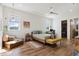 Bright bedroom boasts natural light, wood floors, and stylish decor at 3705 Ridge Run Dr, Minneola, FL 34715