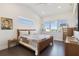Bright bedroom showcases a large window, wood-framed bed, and stylish decor at 3705 Ridge Run Dr, Minneola, FL 34715