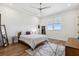 Comfortable bedroom with wood floors, a ceiling fan, neutral decor, and window with blinds at 3705 Ridge Run Dr, Minneola, FL 34715