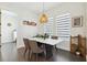 Bright dining room features modern lighting, neutral colors, and two large windows at 3705 Ridge Run Dr, Minneola, FL 34715